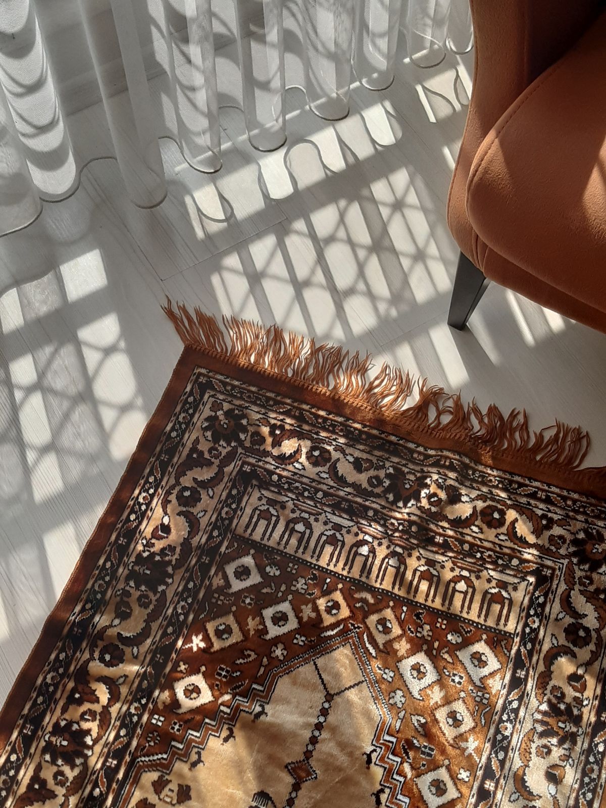 A traditional patterned carpet with decorative motifs.